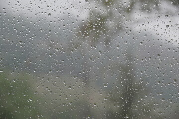 rain water drops on window with mist on outside on cold winter day