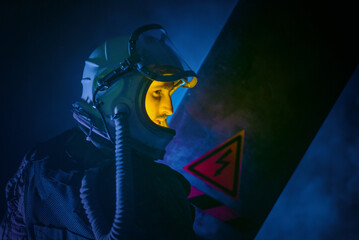 Spaceman or star trooper in the helmet and with rifle in the blue smoke. Science fiction concept.