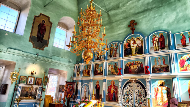 Kirov, Russia - April 09, 2023: Russian orthodox church inside. The unidentified christians people pray. The church candles as background