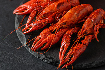 boiled crayfish on a black plate