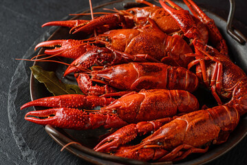 boiled crayfish on a black plate