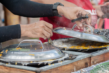 Thai Pancake, Male hands making khanom krok Traditional Thai desserts with delicious - obrazy, fototapety, plakaty