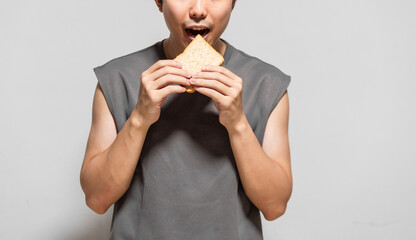 close up of man eating a slice of bread.  - obrazy, fototapety, plakaty