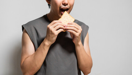 close up of man eating a slice of bread. 