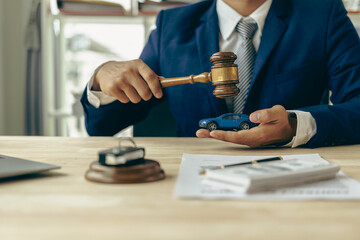 Lawyer, judge's gavel and miniature car as symbols of auction or court action against driver who...