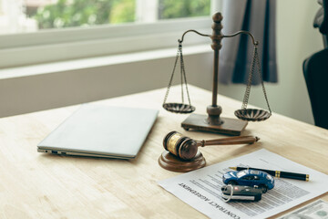 Lawyer, judge's gavel and miniature car as symbols of auction or court action against driver who...