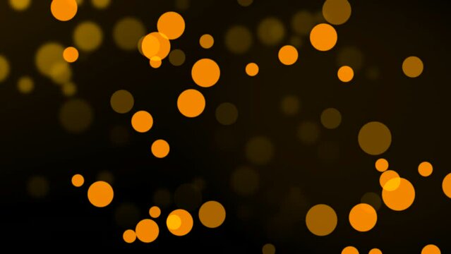 Group of animated orange circle particles moving on bokeh background