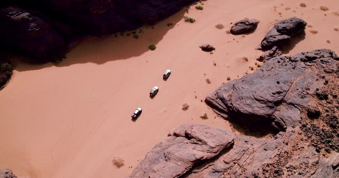 Aerial View of SUV Cars Driving on the Sahara Desert In Tassili n'Ajjer National Park In Djanet, Algeria.
