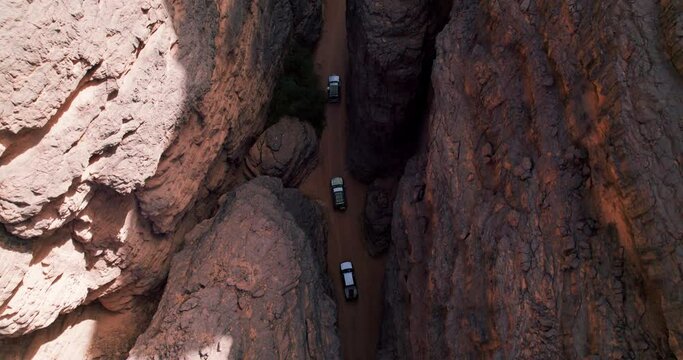 Top View Of Cars Driving Amidst Vast Plateau In Tassili N'Ajjer National Park In Southeastern Algeria. Aerial Shot