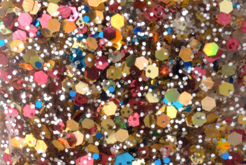 Close-up of multicolored sparkles, backdrop.