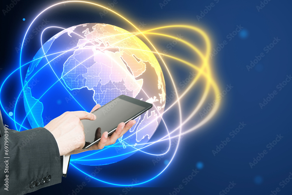 Poster close up of businessman hand pointing at tablet with creative glowing globe hologram on blurry backg