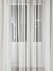 White curtains by the window as an abstract background. Texture