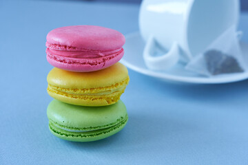 Colorful macaroons on blue background. Selective focus.