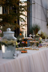 Candy bar on wedding. Candy bar standing of festive table with deserts, cupcakes and macarons.