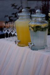 Carafes with refreshing drinks are on the festive table
