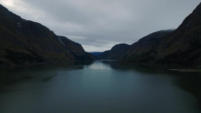 aerial cinematic view over Sandvevatn lake in norwegian mountains druing morning