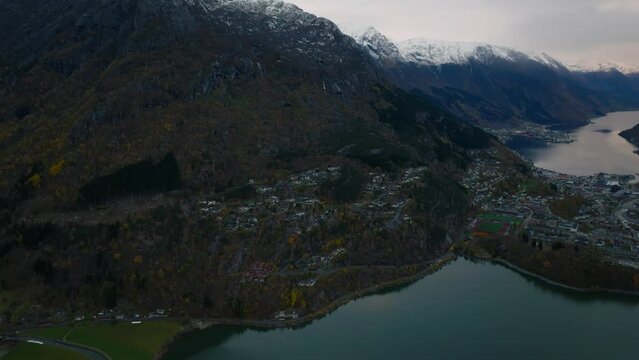 aerial view of city of odda during morning during morning in norway with lakes and mountains on background