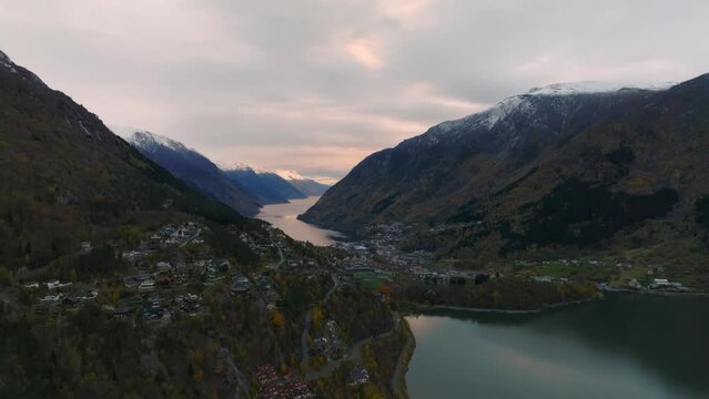 aerial view of city of odda during morning during morning in norway with lakes and mountains on background