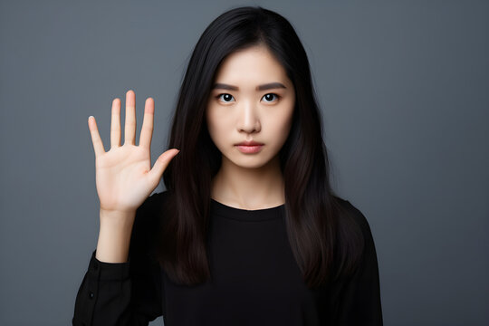 Portrait Of Young Asian Woman Shows The Stop Sign With His Hand