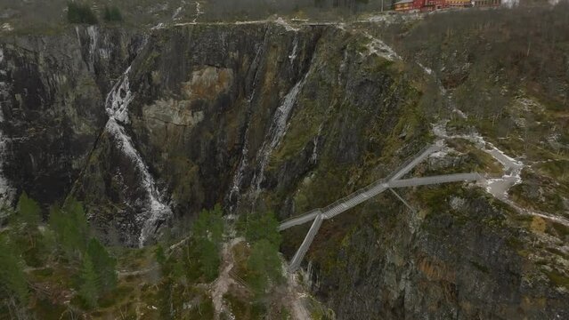 aerial view from drone of a metal bridge on extreme high altitude over canyon of Voringfossen waterfall in norway
