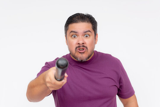 An angry man pointing at someone with a baton. Hostile person intimidating with a blunt weapon. Isolated on a white background.