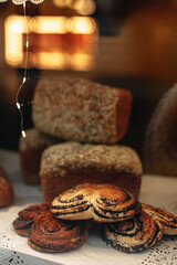 Delicious fresh sweet buns with poppy seeds on a store counter