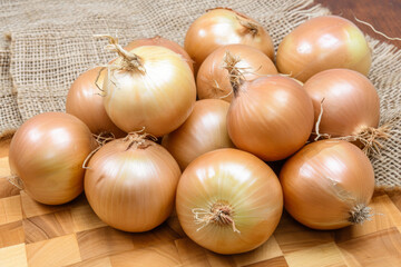A group of fresh onions on a wooden surface