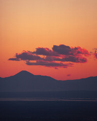 Idyllic landscape of a vibrant sunset sky over rolling mountain peaks