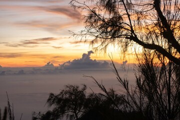 the beauty of the sunrise from the top of the mountain is like a hidden paradise behind the jungle.