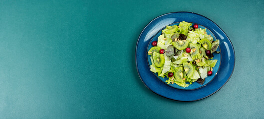 Kiwi salad in a plate - obrazy, fototapety, plakaty