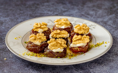 Traditional stuffed dried fig dessert with walnuts and cream, cooked with syrup (Turkish name: fig dessert with cream).​