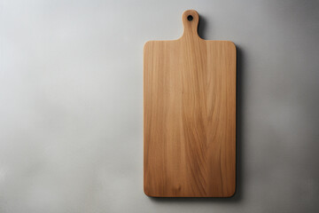 A simple yet elegant wooden cutting board, featuring clean edges and a muted color palette for a minimalist kitchen aesthetic. - obrazy, fototapety, plakaty
