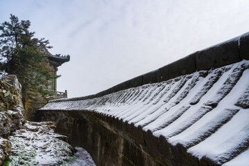 Ancient buildings in China's Wudang Mountains are elegantly decorated with a layer of snow,...