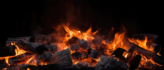 Burning firewood and coals of a fire close up. Background for grilled food with fire.