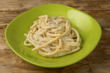 plate of traditional Italian spaghetti Cacio e pepe  with pecorino cheese close up isolated on...