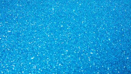 Shining sparkling blue blurred background for holiday design. Christmas abstract sparkles