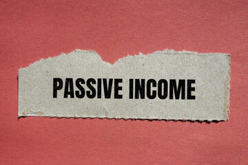 Passive income lettering on ripped paper. Business concept photo.