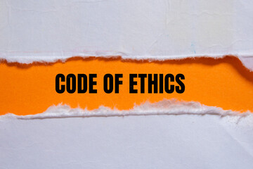 Code of ethics lettering on ripped paper. Conceptual photo.