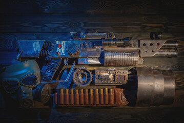 Sci fi post apocalypse pump shotgun and gas mask on the survivor table concept background. - obrazy, fototapety, plakaty