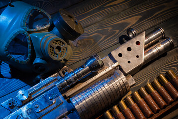 Sci fi post apocalypse pump shotgun and gas mask on the survivor table concept background.