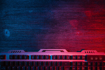 Modern metal computer keyboard on the flat lay desk table background with copy space. Cybersport.