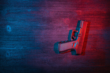 Toy airsoft gun on the black table flat lay background with copy space. Security. Secret service.