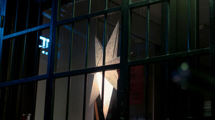 Star in the window of a hairdressers shopfront illuminated by natural light