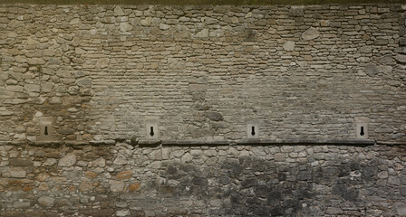 Very old brick stone wall of castle or fortress of 18th century. Full frame wall with obsolete...