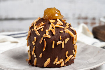 Chocolate cake. Cake with chestnuts, almonds and chocolate on a wooden background. Close up