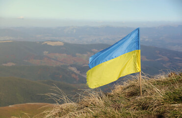 Ukrainian flag on top of Hoverla mountain in Ukraine close up
