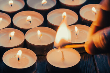 Burning candles on a dark surface. Remembrance Day