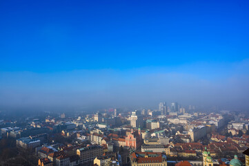 Landscape view on the Ljubljana city from the castle during a windy foggy sunny weather in the...