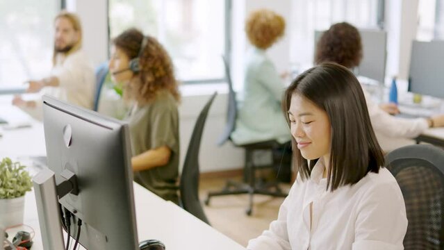 Asian woman working happily in a coworking space