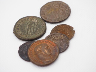 Bronze coins from the Roman Empire on a white background